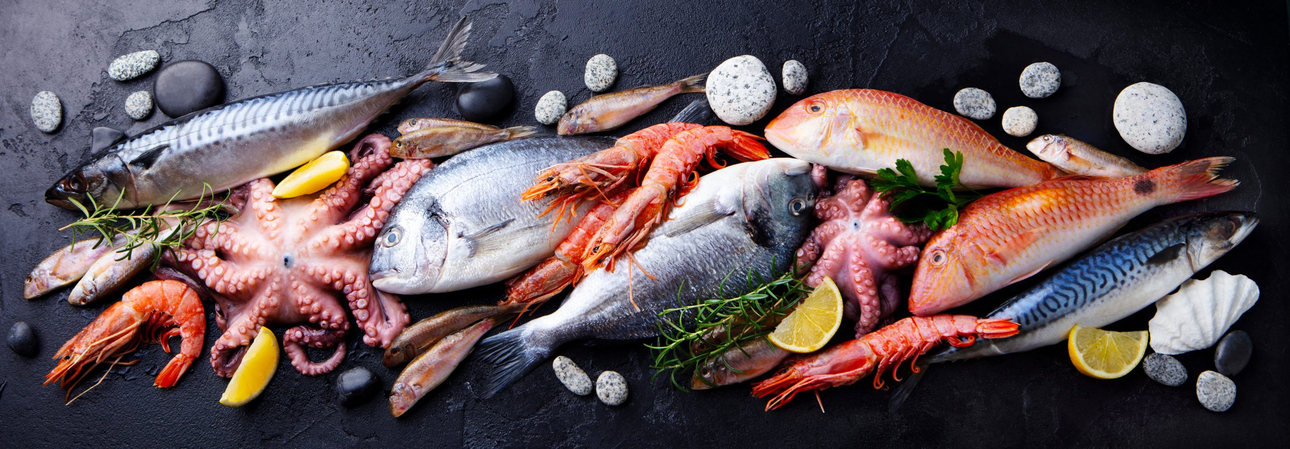 Fresh,Fish,And,Seafood,Assortment,On,Black,Slate,Background.,Top